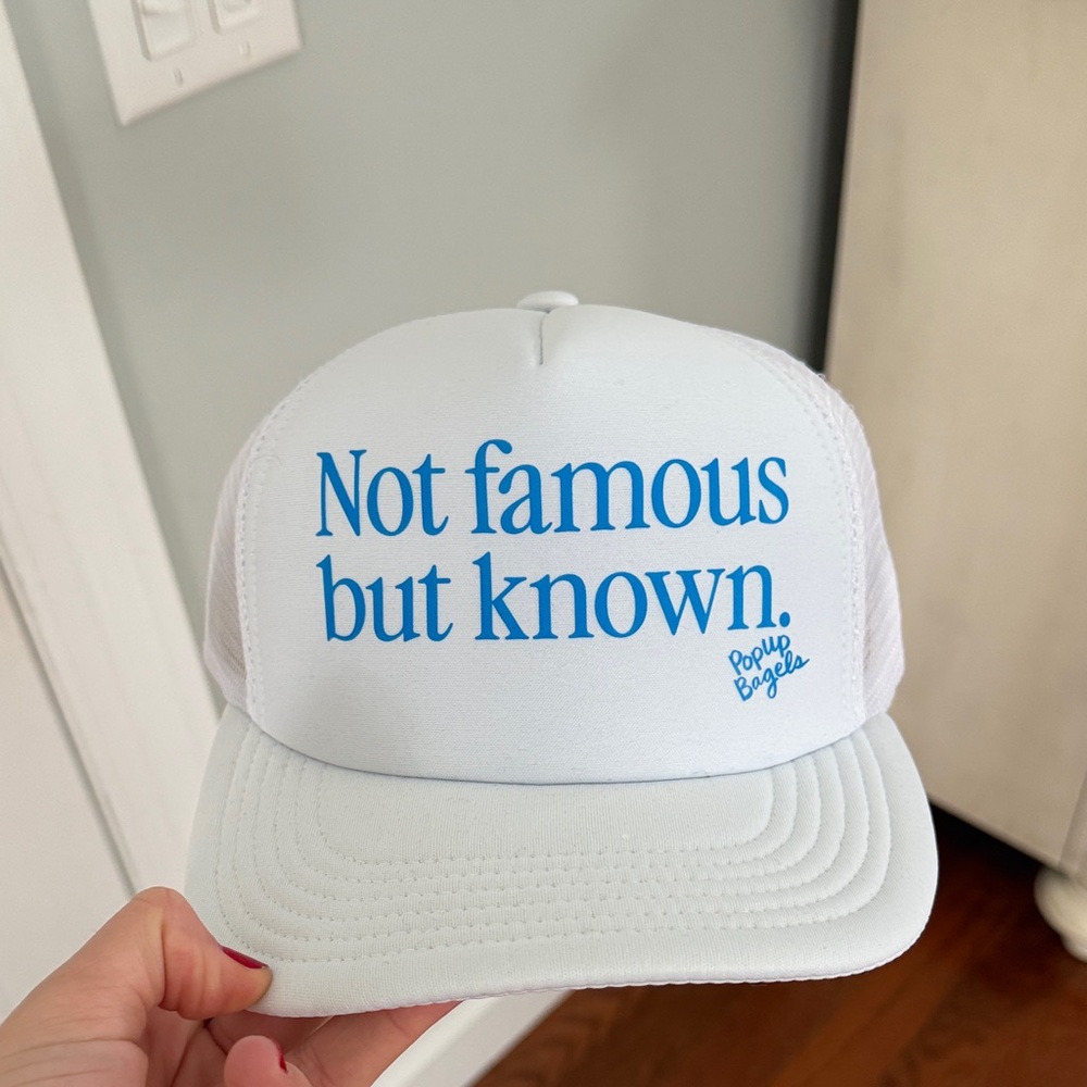 Pop Up Bagels White Trucker Hat with Blue Text